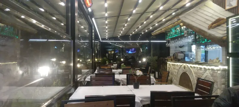 The glass dining room lit up at night