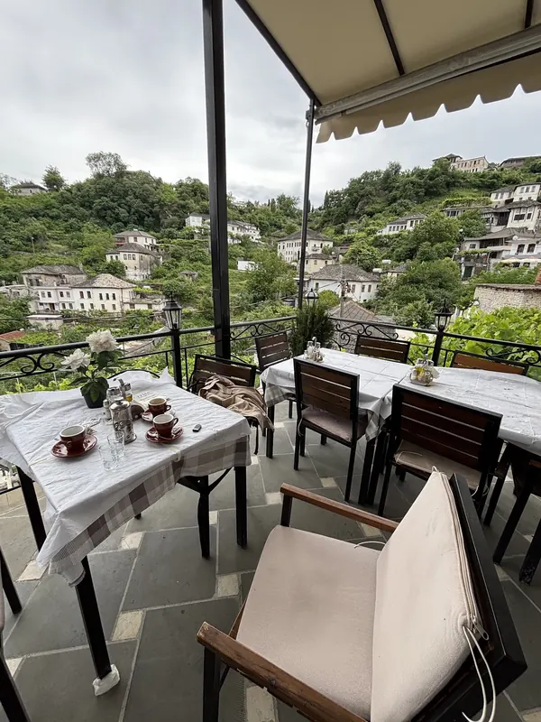 Terrace tables looking across at the stone houses of Gjirokastër's old town